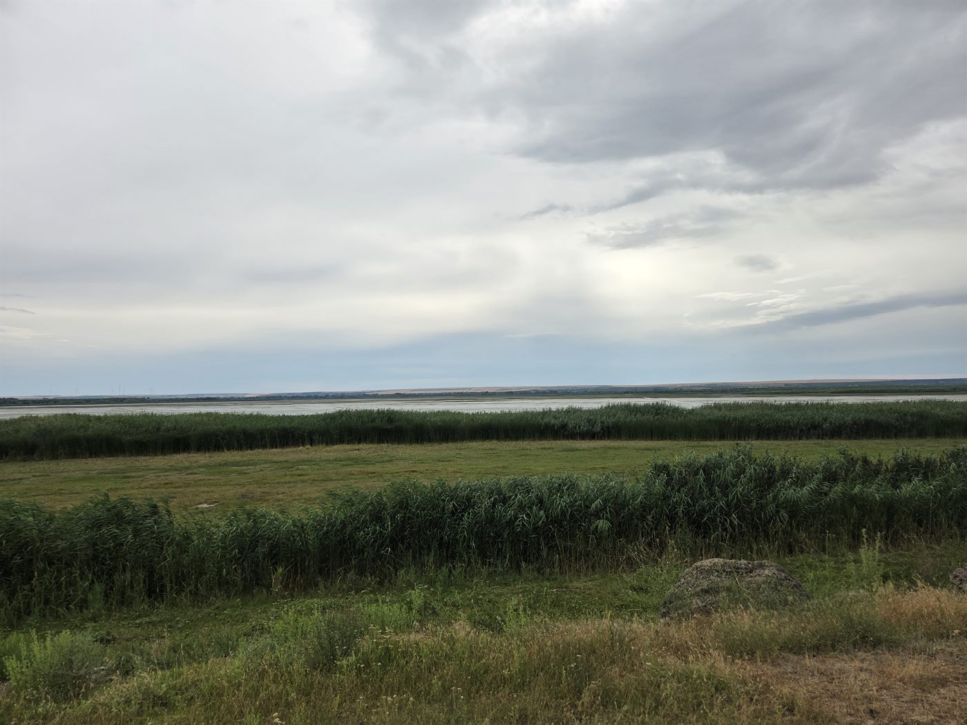 Lake Manta bordered by green wetlands